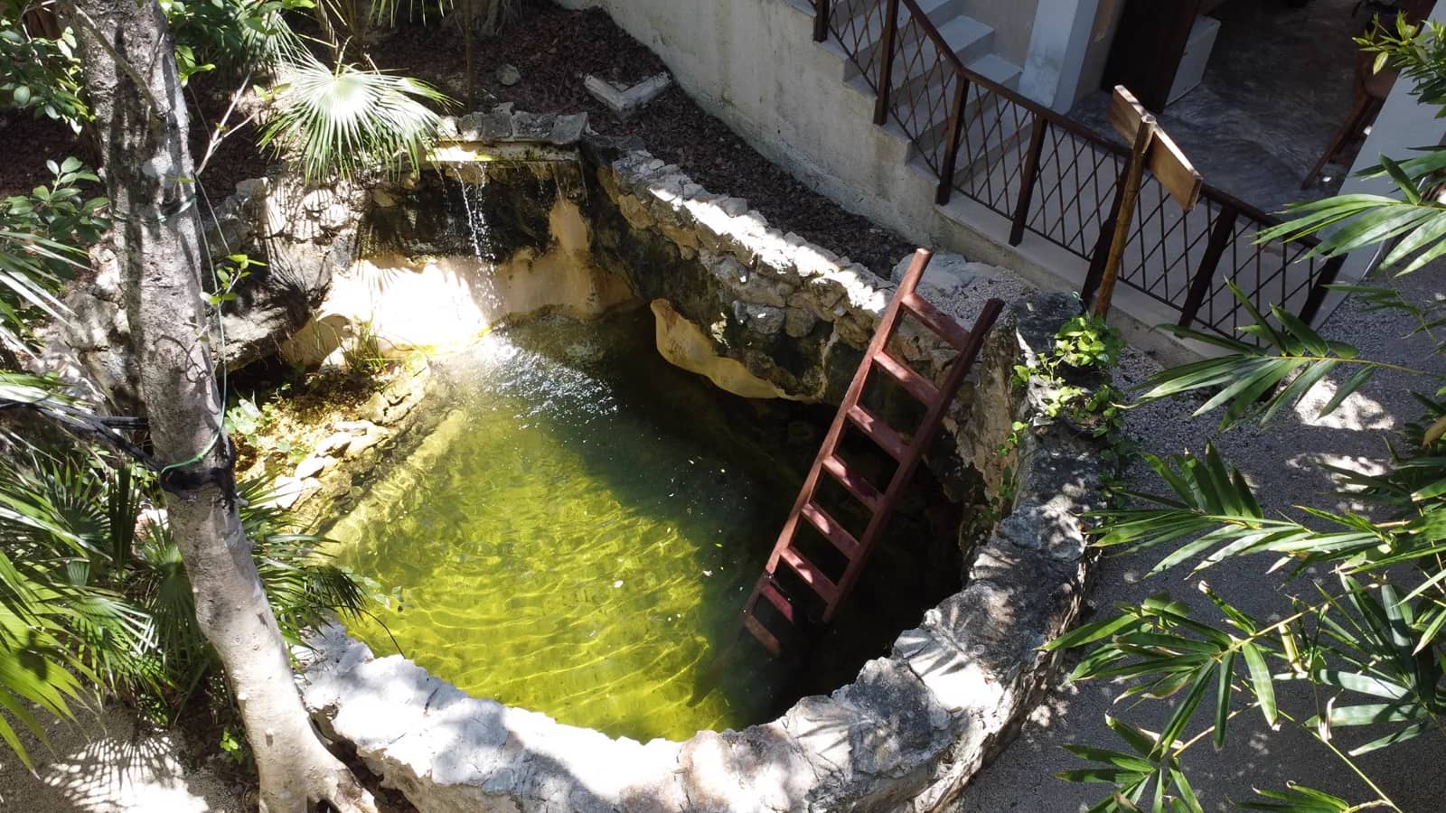 Aerial view of the natural cenote-style pool at Mauna Tulum